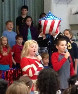 Fifth-graders Meredith Rafferty and Zach Marchese lead the national anthem.