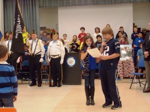 Fifth graders Allia Covino and Connor Veitch lead the singing of the national anthem.