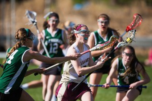 Algonquin’s Mary Rousseau brings the ball upfield thru a host of Wachusett players