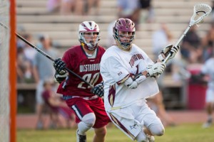 Algonquin’s Zach Skowronek  (#1) prepares to shoot at the goal while being pursued by Westborough’s Stephen Falvey (#20). 