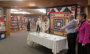 Visitors are greeted at the entrance of the library with a handmade quilt that will be auctioned to raise funds for Northborough’s 250th anniversary in 2016. (Photos/Alexandra Molnar)
