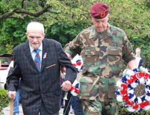 Harvey Chapdelaine, a U.S. Army veteran in World War II, lays a wreath at the World War II – Korean War – Vietnam War Memorial, assisted by Bruce Goldsmith of American Legion Vincent F. Picard Post 234.