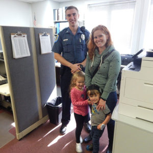 Officer Brendan Woeller with Samantha Sawyer and her children, Michaela, 4, and Jack, Photos/Melanie Petrucci