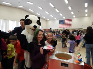 Fourth-graders Devon Bair (left) and Victoria Kebartas enjoy a visit with the Peaslee Panda.