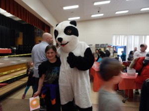 Third-grader Jessica Henriques poses with the Peaslee Panda.