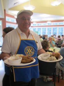 Chuck Frankian, the former Rotary Club of Northborough president, serves up freshly grilled chicken and traditional sides.
