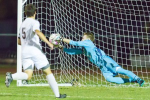 Algonquin goalie Patrick Neusch makes a diving save in the first half.