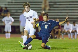 Shrewsbury’s Kyle Simmons attempts a slide tackle to take the ball from Algonquin’s Shawn Sullivan.