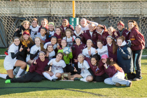 The Algonquin Regional girls soccer team poses with their championship trophy after the game.