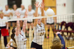 Algonquin’s Kristen Cooley (#23) and Nicole Winkler (#20) leap to block a spike by Lincoln-Sudbury.