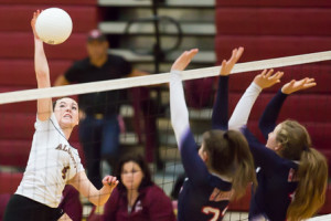 Algonquin’s Elyssa Nicholas (#4) leaps to spike the ball in the third game of the match against Lincoln-Sudbury.