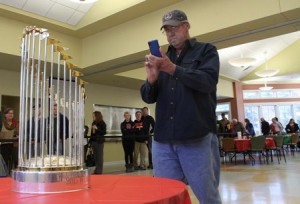 Bob Stone grabs a photo of the trophy Monday at the Northborough Senior Center.