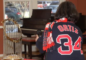 A Red Sox fan photographs the trophy.