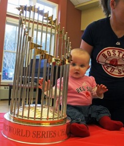 Six-month-old Ella Zietek of Northborough sits near the World Series trophy.