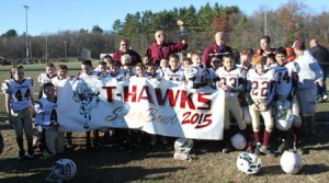 N Youth Football 5th Grade submitted – The Fifth-Grade Northboro-Southboro T-Hawks Central Mass Championship team poses in front of their team banner after defeating Gardner’s Chair City Lions Nov. 8. Photo/submitted 