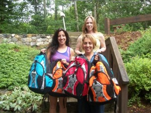 The backpack stuffing team included Tricia Cabral, Liz Nolan (front l to r), and Kristen Recchia. (Photo/Derick Nolan)