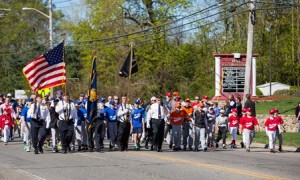 The Vincent F. Picard American Legion Post 234 color guard leads the baseball parade down Main Street. 