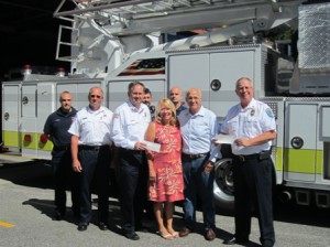 (front, l to r) - Fire Chief Richard Harris, Erla and Kevin Mallett, Police Chief Mark Leahy (back l to r) - FF/EMT Steve Brosque, Captain Dan Brillhart, FF/EMT Todd Yellick, FF/EMT Mike Gaudette  Photo/Bonnie Adams 