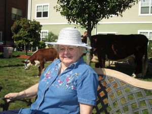 Beaumont resident Ivy Murphy soaks up the last of the warm autumn weather as a cow and its calf graze in the shade behind her.