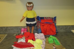 A sample of what each girl receives - a tote with a doll and a hand-sewn wardrobe.