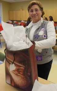 Volunteer Marie O'Brien stuffs a gift bag for a senior. This is the first year she has been involved with this project. 