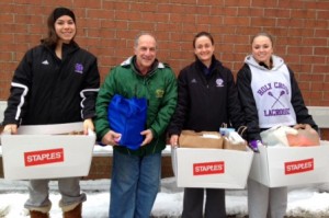 Central Mass. Club Lacrosse and Holy Cross women’s lacrosse work to help stock a local food pantry. (l to r) Holy Cross lacrosse player Sophia Agostinelli, Joe Kacevitch, Stephanie Ridolfi and Holy Cross player Maddie Ward. (Photo/submitted)
