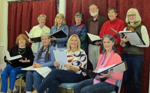 Members of the Journey Home Singers practice from their next performance: (seated, l to r) Mary Beland, Judy Bissett, Jan Racca, Yvette Kite, (standing, l to r) Karleen Chase, Marjorie Peairs, Director Kathy Todd, Dennis Deyo, Jennifer Todd and Anne Deysher. (Photo/submitted)