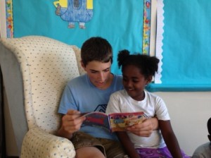 Counselor Spencer Geary and Debritu Calderone, 6, enjoy reading a book together. (Photo/submitted)