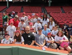 Red Sox players David Ross (front row, center left) and Brock Holt (front row, center right) meet the kids.