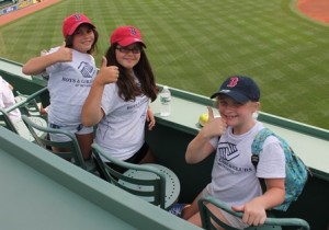 (l to r) Erin Bourque, Kaylie Wilder and Fiona Lee gives a thumbs-up atop the Green Monster.