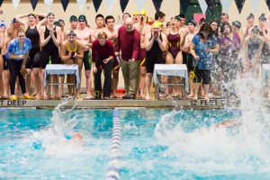 Shrewsbury (left) and Algonquin (right) swimmers cheer on their teammates during the final heat of the girls’ 200 yard medley relay,