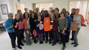 Patrick Ssenyonjo (center front in apron) surrounded by Days for Girls Chapter members Photo/Melanie Petrucci