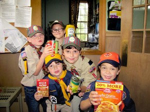 Southborough scouts hold up some of the donations collected in last year's drive.  Photo/submitted 