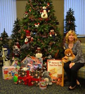 Lynne M. Esposito, VP and Mortgage Division manager of SpencerBANK and bank coordinator for the Spencer Toys for Tots program, poses with donations recently made at the bank’s main office.