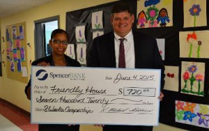 Danielle Delgado (left), director of child, youth, and family programs at Friendly House and K. Michael Robbins, president and CEO of SpencerBANK. (Photo/submitted)