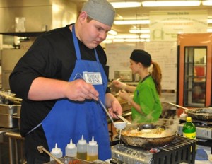 Senior P.J.Sanders of Clinton prepares food in the Culinary Arts Department for Assabet Valley Regional Technical High School's Exhibit/Admissions Night. (Photo/submitted)