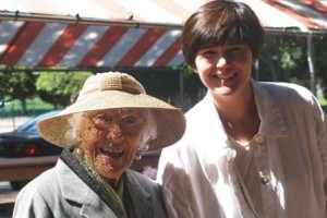 Representative Carolyn Dykema (right) and a senior citizen soak in the sunshine at the annual senior picnic.
