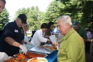 Volunteers serve guests at the annual senior picnic.