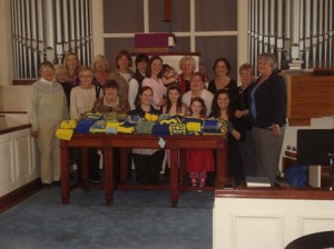 Members of Southborough's Pilgrim Church with scarves they have knitted for Boston Marathon runners. (Photo/submitted)