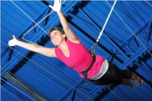 Sue Loverso swings on the flying trapeze. 
