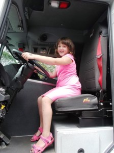 Grace, 6, sits inside a fire truck. 