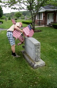 Patrick Moran of Troop 1 Southborough shows his patriotism by placing flags on graves of veterans.