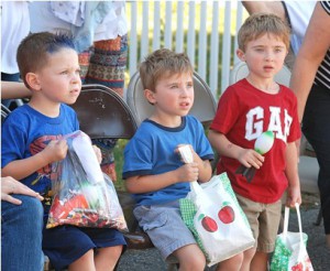 On the lookout for goodies to be tossed from a float are the 4-year-old Hutchinson boys: (l to r) Connor with his twin cousins Barry and Anthony.