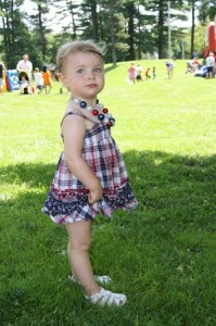 Teaghan Jaquith, 22 months old, takes a break from eating her hot dog to pose in her red white and blue outfit and matching accessories. (Photo/Molly McCarthy)