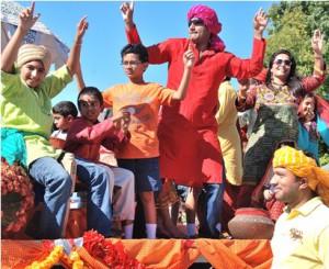 The India Society of Worcester is represented with all ages riding a float.
