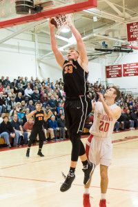 Marlborough’s Chris Doherty (#33) goes up high as he shoots.