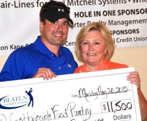 State Rep. Matt Beaton, R-Shrewsbury, presents a check to Wendy Mickel of the Westborough Food Pantry in this photo taken at the 2012 inaugural event. 