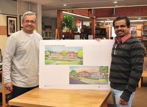 Vinay Vyas and Arumugham Raghunathan display the architect drawing of the remodeled Shrewsbury Public Library. (Photo/Ed Karvoski Jr.)