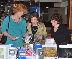 Perusing the silent auction items are (l to r) Tracey Zeckhausen, Ellen Goodman and Elaine Lapomardo.