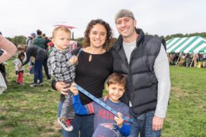 Logan Gravel, age 2, along with his parents, Jessica and Tim, and cousin Hunter Viscomi, age 7, of Upton, enjoys the 10th annual Verrill Farm Harvest Festival held in Concord recently.